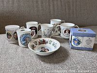 Group shot of six loose mugs, boxed mug and bowl