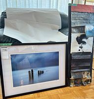 Both framed works standing side by side