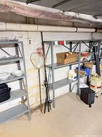 Full view of gray steel shelving rack with five shelves, linked to adjacent units, showing overall size and structure