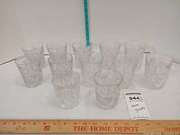 Front view of all 12 cut crystal tumblers with measurement rulers for scale