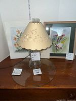 Full lot showing lamp, two framed prints, and round glass top