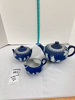 Overall view of teapot, sugar bowl, and creamer