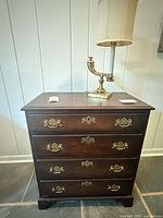 Chest with four drawers and lamp on top