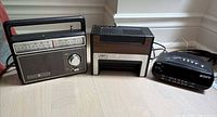 Group shot of three radios: GE portable, Pulser clock radio, Sony clock radio