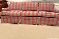 Front view of striped sofa showing three seat cushions and skirt