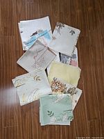 Group view of stacked fabric swatches on wood floor