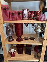 Full shelving view showing entire assortment of red and silver mercury glass vases, votives, candlesticks and goblets