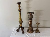 Group shot of three ornate pedestal candle holders