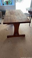 Side profile view of pine trestle dining table
