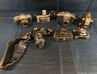 All seven cameras arranged on blue background