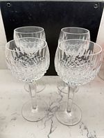 All four cut crystal wine glasses displayed