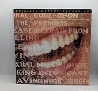 Front of album sleeve showing artwork and mastering strip