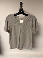 Front view of Oak + Fort striped t-shirt on hanger