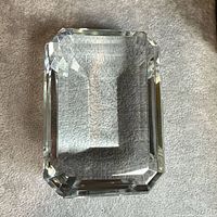 Top view of rectangular crystal paperweight on grey surface
