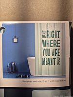 Front of packaged shower curtain showing design and text