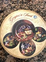 Circular retail box showing Grapes'n Such artwork and set details