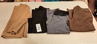 Overview of four clothing pieces laid flat