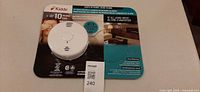Front view of packaged Kidde smoke & CO alarm showing unit and branding