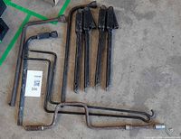 All eight tire tools laid out on concrete floor