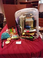 overview of storage bin with assorted gift bags, boxes, ribbons and filler