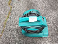Top view showing teal housing, handle, cord wrap