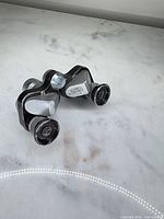 Front angled view of compact Bushnell opera glasses showing overall design and wear