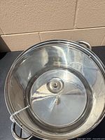 Interior view of stainless steel stock pot with lid inside