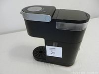 Left side view showing body, reservoir, drip tray