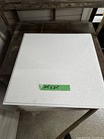 Top view of a single 24" x 24" white textured ceiling tile