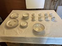 Full dinnerware set laid out on table