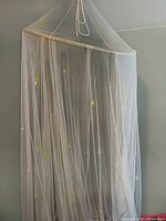 Full view of hanging bed canopy showing shape and drape