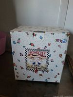 Full view of floral printed retail box showing Mary Engelbreit At Home label