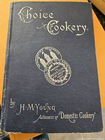 Front cover showing title, author and decorative medal