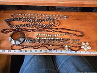 All six natural material necklaces laid out for scale