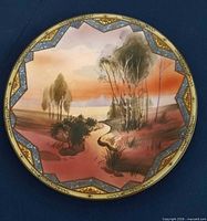 Full view of round Nippon porcelain plaque showing painted landscape and enamel border