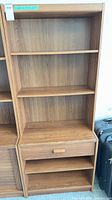 Front view of full bookcase showing shelves and drawer