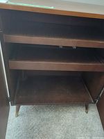 Cabinet interior showing pull-out shelves and tapered leg base