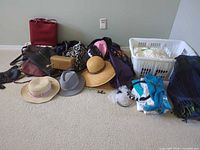Overall view of lot showing handbags, hats, scarves, linens in basket