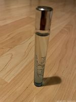 Full view of sealed perfume bottle standing upright