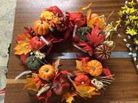 Autumn wreath on table with ruler for scale