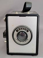 Front view showing lens, branding, front panel texture