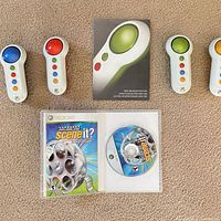 Overview of game with case, disc, instruction booklet and four Big Button Pad controllers