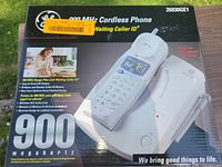Front of sealed GE 900 MHz cordless phone box showing model and features