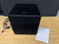 KEF Kube series subwoofer front/top view with power cable and user manual