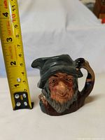 Front view of character jug with measuring tape showing approx 3 in height