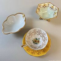 Group shot of teacup with saucer, hexagonal footed dish, leaf-shaped dish