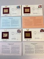 All four FDCs laid out showing gold replicas, stamps and info cards