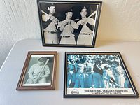 Overview of the three framed baseball photos on table