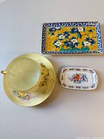 Cup, saucer, trinket dish, tray overhead view