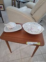 Tureen and sugar bowl on small table showing pattern and scale